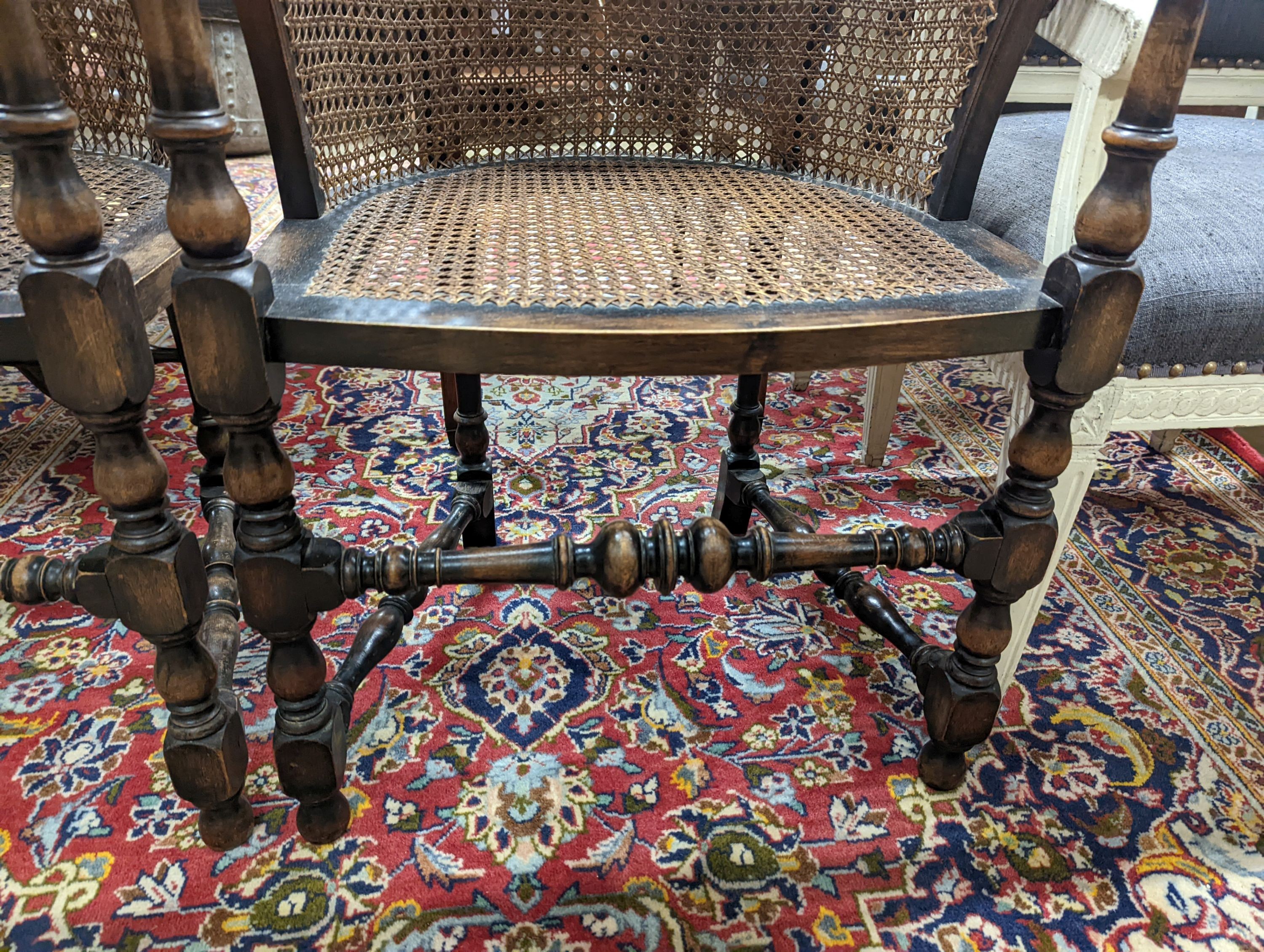 A pair of early 20th century Carolean style caned beech tub framed chairs, width 56cm, depth 48cm, height 85cm